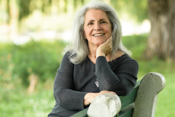 Marlene Blumin, CALS Ph.D. ’88 sitting on a park bench