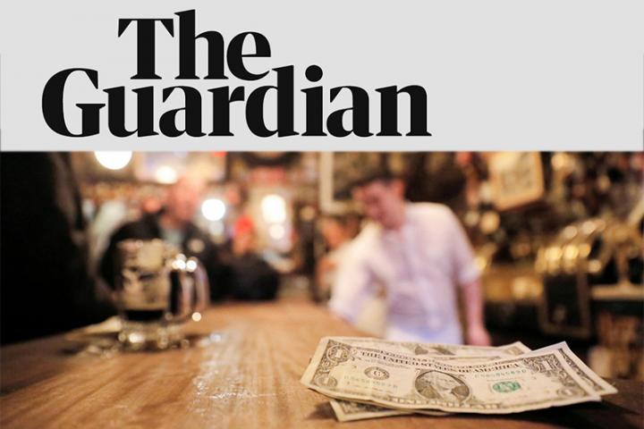 The Guardian. Cash laying on a bar with a bartender in the background.