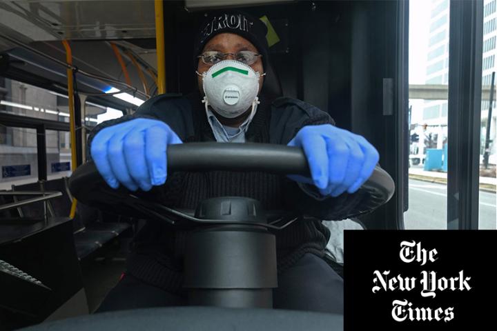 A bus driver in Detroit wearing protective gear to help prevent the spread of the coronavirus.Credit...Seth Herald/Agence France-Presse — Getty Images